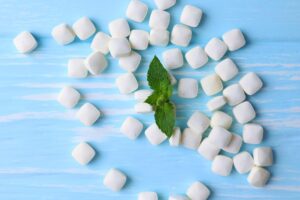 Chewing gum for reducing acid reflux through saliva production